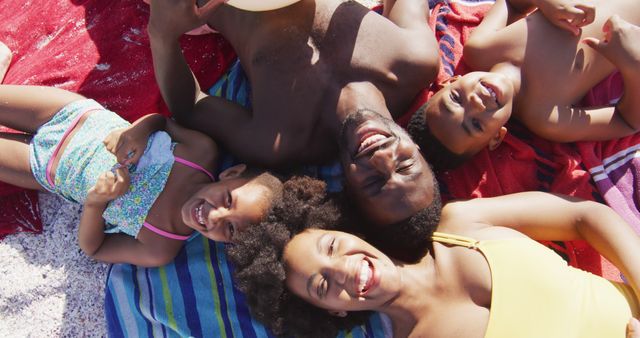 Happy Family Lying on Beach Towels Enjoying Summer - Download Free Stock Images Pikwizard.com