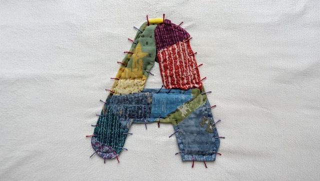 Creative textile art: stitched patchwork letter a