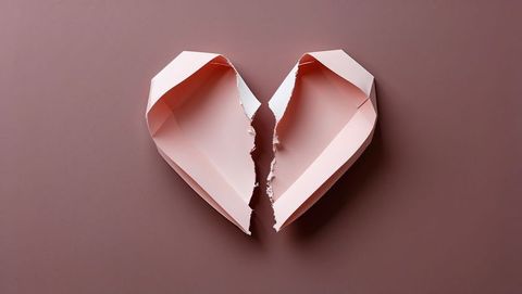 Broken Pink Paper Heart Symbolizing Vulnerability