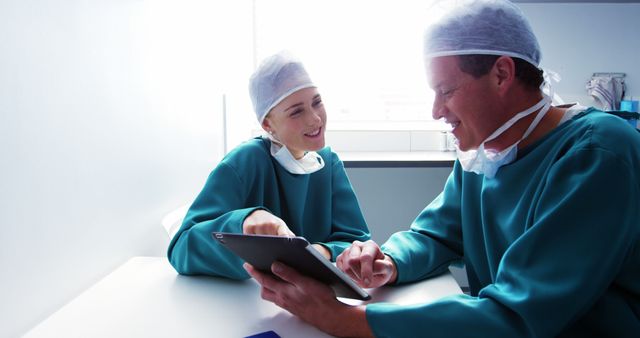 Surgeons in Hospital Discussing Patient Data on a Digital Tablet - Download Free Stock Images Pikwizard.com