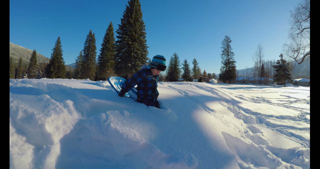 Child Playing in Deep Snow with Sled in Winter Wonderland - Download Free Stock Images Pikwizard.com