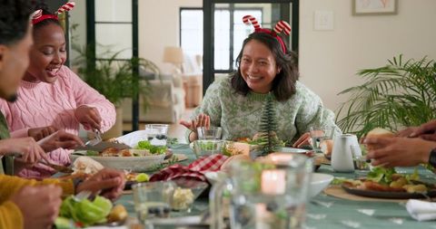 Friends Hosting Festive Seasonal Gathering over Holiday Feast