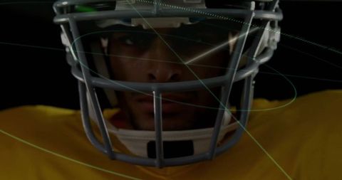 American Football Player Wearing Helmet in Dramatic Lighting