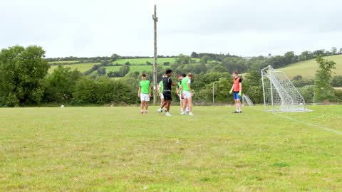 Teen Soccer Team Practicing on Countryside Field