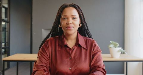 Confident Businesswoman Sitting at Office Desk in Modern Workplace