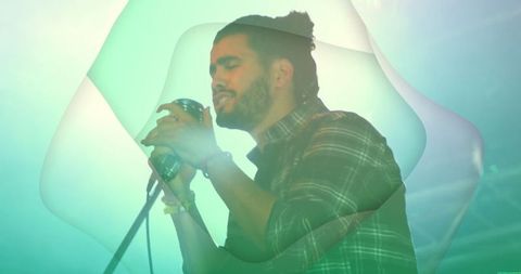 Male singer performing with retro microphone in moody concert lighting