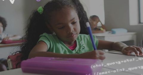 Young Student Writing Enthusiastically in Classroom Setting