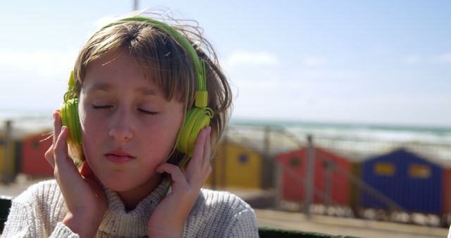 Child Enjoying Music with Headphones on Beach - Download Free Stock Images Pikwizard.com