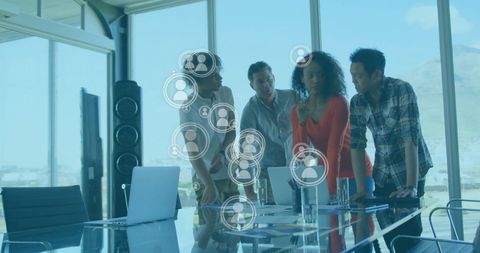 Diverse Team Analyzing Data with Digital Graphics in Modern Office