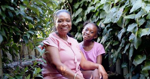 Grandmother and granddaughter enjoying peaceful garden moment