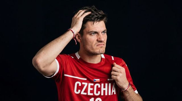 Tense czechia soccer fan wearing red jersey #19 gripping hair and fist, studio portrait