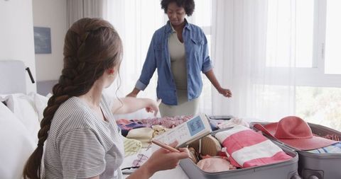 Lesbian Couple Packing Suitcase, Preparing for Vacation