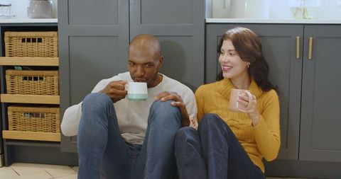 Cozy Kitchen Moments: Couple Enjoying Warm Drinks Together