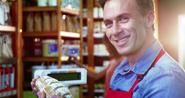 Portrait of smiling staff holding bread in super market 4k