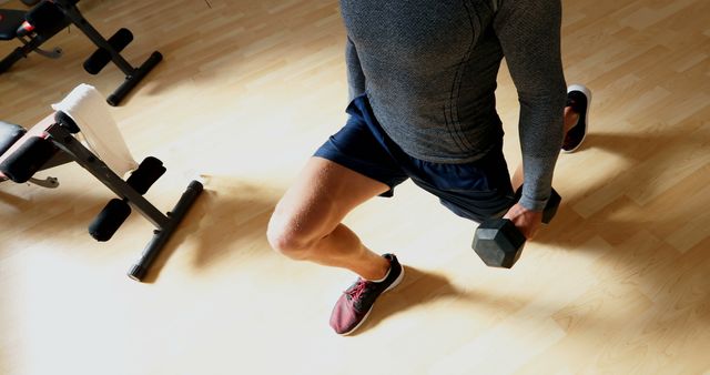 Man Exercising with Dumbbell Lunge at Home Gym - Download Free Stock Images Pikwizard.com