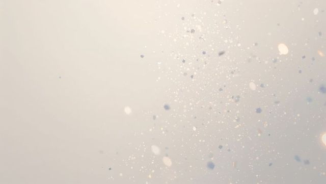 Ethereal shimmering particles drifting across soft gradient with bokeh and lens flare