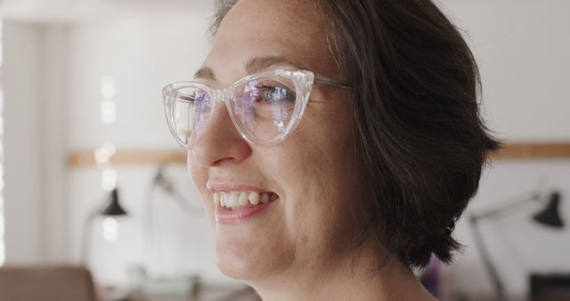 Smiling Woman with Glasses in Office Environment - Download Free Stock Images Pikwizard.com