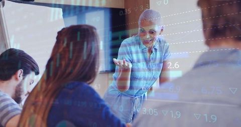 Woman leading data-driven team workshop with analytics overlay in modern boardroom