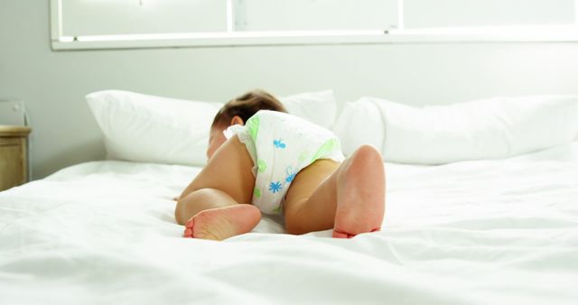 Baby Crawling Wearing Diaper on White Bed - Download Free Stock Images Pikwizard.com