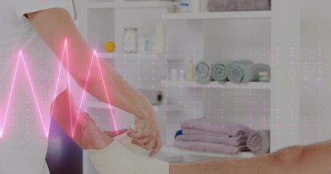 Physiotherapist applying bandage to foot with heart rate overlay
