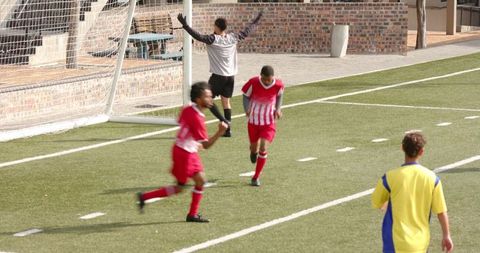 Football Team Celebrating Goal on Sunny Day