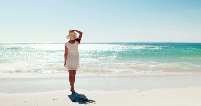 Woman Relaxing on Sandy Beach with Blue Ocean and Clear Sky - Download Free Stock Images Pikwizard.com