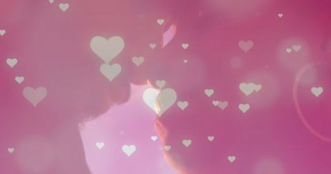 Diverse Couple's Romantic Moment in Pink Heart Glow