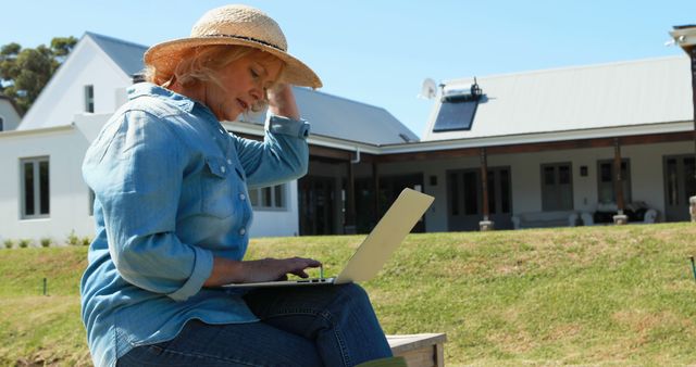 Senior Woman Using Laptop Outdoors at Rural House - Download Free Stock Images Pikwizard.com