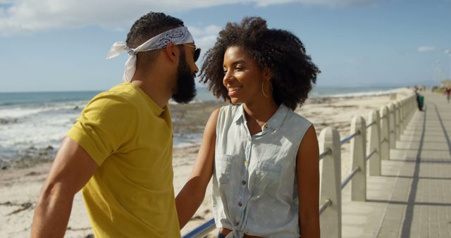 Romantic diverse couple standing and smiling on sunny promenade, copy space. Summer, vacation, romance, love, relationship, free time and lifestyle, unaltered.