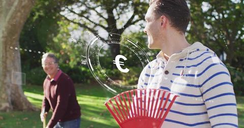Two men raking leaves in sunny backyard with euro currency hud overlay concept for finance