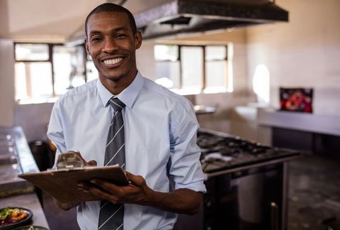 Restaurant manager conducting kitchen inspection
