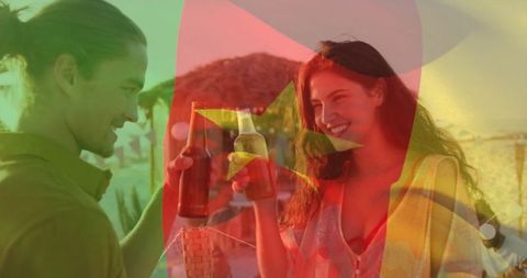 Smiling Couple Toasting Beers at Seaside Beach Lounge