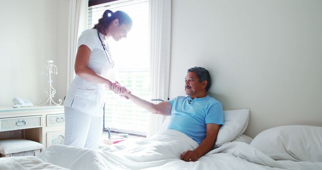 Nurse Holding Hand of Elderly Man in Hospital Bed - Download Free Stock Images Pikwizard.com