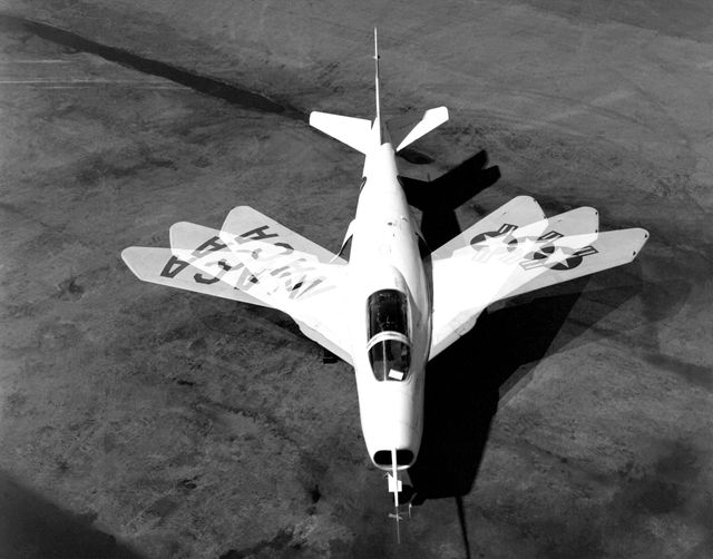 Historic jet aircraft X-5 demonstrating variable wing sweep capability at Edwards Air Force Base South Base. Provides a glimpse into high-speed aerodynamics research by NACA. Useful for articles on aviation history, educational materials about jet aerodynamics, or exhibits focusing on mid-20th century experimental aircraft design.
