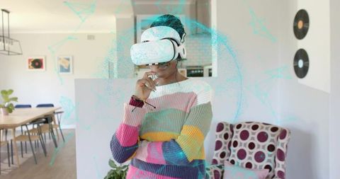 Woman Exploring Virtual Reality in Modern Living Space