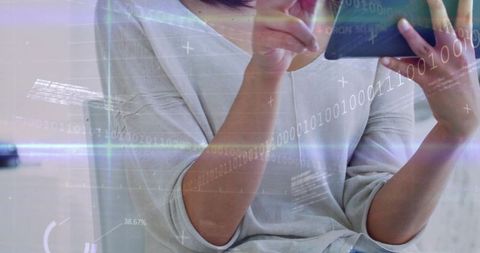 Woman using tablet with futuristic binary hud overlays showing data and analytics