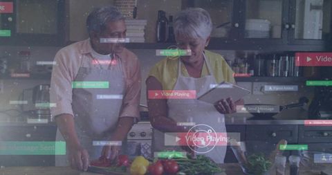 Senior couple cooking together using tablet for recipe guidance in modern home kitchen