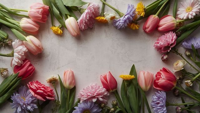 Pastel spring floral frame featuring pink tulips, mums, asters and yellow daisies