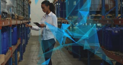 Businesswoman Monitoring Inventory with Technology in Warehouse