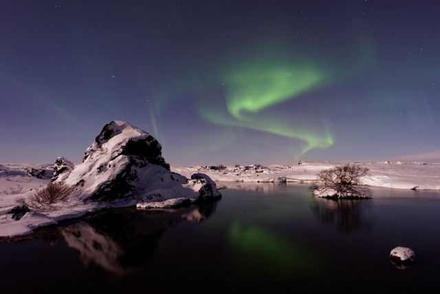 Mesmerizing Northern Lights Over Snowy Landscape with Reflection in Water - Download Free Stock Photos Pikwizard.com