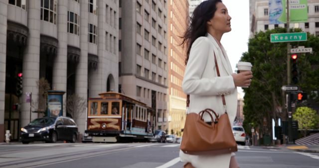 Confident woman walking in urban city holding takeaway coffee - Download Free Stock Images Pikwizard.com