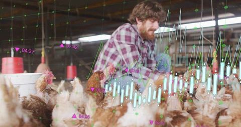 Farmer monitoring poultry with real-time analytics and sensor visualization in barn