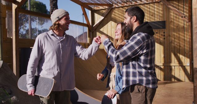 Image of happy diverse female and male skateboarders in skate park. Skateboarding, sport, active lifestyle and hobby concept.