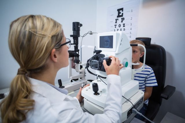 Female optometrist examining young patient on coreometry in ophthalmology clinic
