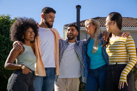 Diverse Friend Group Enjoys Sunlit Suburban Setting