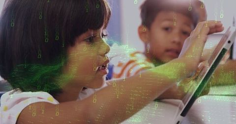 Children Engaged with Tablet in Classroom Setting Featuring Binary Overlay