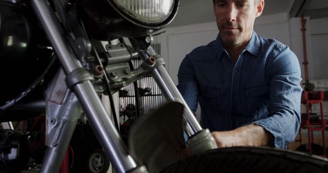 Mechanic Repairing Motorcycle Front Suspension in Workshop - Download Free Stock Images Pikwizard.com