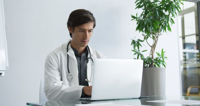 Male Doctor Working on Laptop in Modern Office - Download Free Stock Images Pikwizard.com