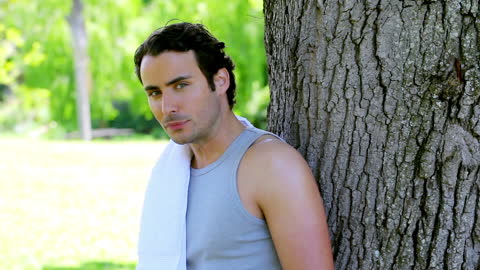 Man Relaxing with Water Bottle in Nature