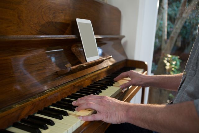 Man Playing Piano with Tablet at Home - Download Free Stock Photos Pikwizard.com